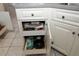White kitchen cabinets with pull-out drawers for optimized space and convenient access to cookware at 9129 Sw 193Rd Cir, Dunnellon, FL 34432