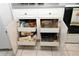 White kitchen cabinets with pull-out drawers for organized storage and easy access to bakeware at 9129 Sw 193Rd Cir, Dunnellon, FL 34432