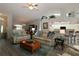Open living room with vaulted ceilings, wood floors, and seamless kitchen access at 9129 Sw 193Rd Cir, Dunnellon, FL 34432