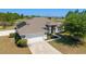 Desirable property featuring a well-manicured lawn, solar panels, and proximity to community amenities at 9595 Sw 51St Cir, Ocala, FL 34476