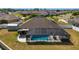 Aerial view shows a home with screened pool, spa, and spacious yard at 9595 Sw 51St Cir, Ocala, FL 34476