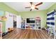 Bedroom with hardwood floors, ceiling fan, and adjacent sitting area at 9595 Sw 51St Cir, Ocala, FL 34476