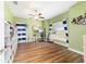 Bright bedroom with hardwood floors, ceiling fan, and natural light at 9595 Sw 51St Cir, Ocala, FL 34476
