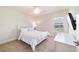Well-lit bedroom featuring a comfortable bed, a ceiling fan, and a dedicated desk area with plenty of natural light at 9595 Sw 51St Cir, Ocala, FL 34476