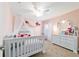 Cozy bedroom with soft pink walls, charming decor, and abundant natural light, perfect for a Bedroom at 9595 Sw 51St Cir, Ocala, FL 34476