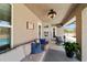 Relaxing covered patio with wicker furniture, ceiling fan, and view of the pool at 9595 Sw 51St Cir, Ocala, FL 34476
