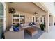 Relaxing outdoor patio area with comfortable wicker furniture, a ceiling fan, and a tranquil ambiance at 9595 Sw 51St Cir, Ocala, FL 34476