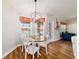 Eat-in dining area features a wood table, chandelier and view of the pool at 9595 Sw 51St Cir, Ocala, FL 34476