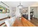 Dining room features a wood table, chandelier, bright window, and wood floors at 9595 Sw 51St Cir, Ocala, FL 34476