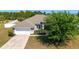 Charming single-Gathering home with a two-car garage, lush lawn, and mature landscaping at 9595 Sw 51St Cir, Ocala, FL 34476