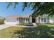 Attractive home exterior featuring a well-manicured lawn, tidy landscaping, and inviting entrance at 9595 Sw 51St Cir, Ocala, FL 34476