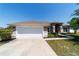 Well-maintained one-story home with a two-car garage, manicured lawn, and inviting curb appeal at 9595 Sw 51St Cir, Ocala, FL 34476