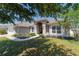 Well-maintained one-story home with a manicured lawn, mature trees, and inviting curb appeal at 9595 Sw 51St Cir, Ocala, FL 34476