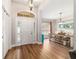 A well-lit foyer opening to a dining area and featuring wood-look floors at 9595 Sw 51St Cir, Ocala, FL 34476
