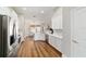 Bright kitchen features stainless steel appliances, white cabinets and wood floor at 9595 Sw 51St Cir, Ocala, FL 34476