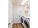 Bright laundry room features wood-look floors and modern washer and dryer at 9595 Sw 51St Cir, Ocala, FL 34476