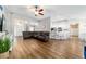 Open-concept living space with wood flooring, seamlessly connecting the living room and kitchen areas at 9595 Sw 51St Cir, Ocala, FL 34476