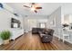 Spacious living room featuring wood floors and a comfortable leather sectional sofa at 9595 Sw 51St Cir, Ocala, FL 34476