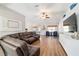 Spacious living room with wood floors, ceiling fan and a large sectional sofa at 9595 Sw 51St Cir, Ocala, FL 34476