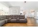 Comfortable living room featuring a leather sectional sofa and an open layout with wood floors at 9595 Sw 51St Cir, Ocala, FL 34476