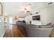 Well-lit living area with wood floors, sectional sofa, and a ceiling fan at 9595 Sw 51St Cir, Ocala, FL 34476