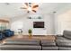 Cozy living room with wood floors, blue accent chairs, and a ceiling fan at 9595 Sw 51St Cir, Ocala, FL 34476