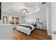 Spacious main bedroom features a tray ceiling, hardwood floors and a large window at 9595 Sw 51St Cir, Ocala, FL 34476