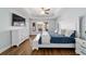 This is the main bedroom which features a tray ceiling and hardwood floors at 9595 Sw 51St Cir, Ocala, FL 34476