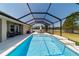 A private screened-in pool with stepping stones, a backyard view, lounge furniture and a covered patio at 9595 Sw 51St Cir, Ocala, FL 34476