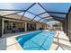 Inviting pool area with lounge seating, outdoor dining, and a screened enclosure for relaxed and private outdoor living at 9595 Sw 51St Cir, Ocala, FL 34476