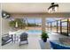 An outdoor living space offering a screened pool, fan, and ample seating at 9595 Sw 51St Cir, Ocala, FL 34476