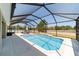Beautiful blue swimming pool with screened-in enclosure offering a relaxing outdoor retreat with lounge chairs at 9595 Sw 51St Cir, Ocala, FL 34476