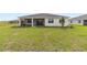 Expansive backyard featuring beautiful landscaping, green grass, and a view of the covered patio at 9871 Sw 105Th Ct, Ocala, FL 34481