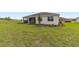 Spacious backyard with green grass, landscaping, and a screened-in patio at 9871 Sw 105Th Ct, Ocala, FL 34481