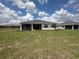 Exterior view of home showcasing backyard and patio at 9871 Sw 105Th Ct, Ocala, FL 34481