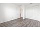 Bedroom featuring stylish gray wood floors, an ensuite bathroom, and a closet with sliding doors at 9871 Sw 105Th Ct, Ocala, FL 34481