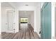 Bright foyer showcasing wood-look flooring and an open layout leading to living spaces at 9871 Sw 105Th Ct, Ocala, FL 34481