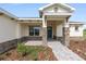 Inviting front entrance with stone pillar accents and well-manicured landscaping at 9871 Sw 105Th Ct, Ocala, FL 34481