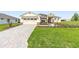 Inviting single-story home with a two-car garage, lush lawn, and attractive landscaping at 9871 Sw 105Th Ct, Ocala, FL 34481