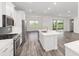 Modern kitchen with stainless appliances, stone countertops, and tile backsplash at 9871 Sw 105Th Ct, Ocala, FL 34481