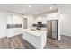 Modern kitchen with a large island, stainless steel appliances, and gray backsplash at 9871 Sw 105Th Ct, Ocala, FL 34481