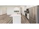 Modern kitchen with a large island, stainless steel appliances, and white cabinets at 9871 Sw 105Th Ct, Ocala, FL 34481