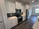 Stylish kitchen featuring white cabinets, stainless steel appliances, and modern backsplash at 9871 Sw 105Th Ct, Ocala, FL 34481