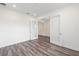 A spacious living room with plank flooring, white walls, and frosted glass french doors that lead to another room at 9871 Sw 105Th Ct, Ocala, FL 34481