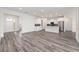 Bright open-plan living space with white cabinets and modern appliances at 9871 Sw 105Th Ct, Ocala, FL 34481