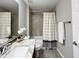 Bathroom featuring gray granite countertop, white sink, and tiled shower at 9983 Sw 188Th Cir, Dunnellon, FL 34432