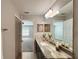 Bright bathroom with granite countertop, large mirror, and views into the bedroom at 9983 Sw 188Th Cir, Dunnellon, FL 34432