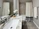 Modern bathroom featuring gray granite countertop, white sink, and shower at 9983 Sw 188Th Cir, Dunnellon, FL 34432