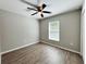 A well-lit bedroom features a ceiling fan and a window with wood-look flooring at 9983 Sw 188Th Cir, Dunnellon, FL 34432
