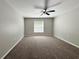 Spacious bedroom featuring neutral walls, carpeted floors, and a ceiling fan at 9983 Sw 188Th Cir, Dunnellon, FL 34432